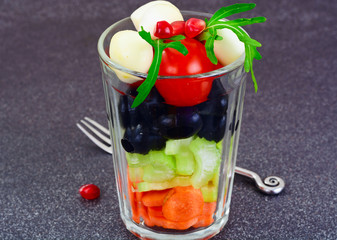 Dietary delicious salad in glass of arugula, pear, walnut, mozza