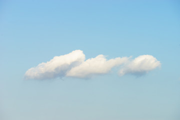 Puffy white clouds against blue sky background