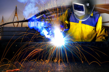Worker welding and rope bridge background.