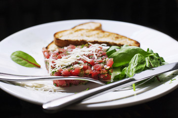 Tartare of beef with spinach.