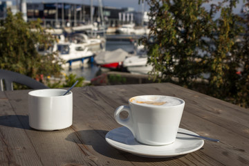 Drinking coffee in a coffee shop with blurry port background