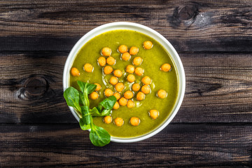 Broccoli soup or cream soup on wooden table.