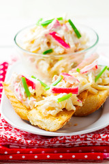 salad from crab sticks on toasts from baguettes