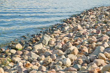 The river Bank is lined by boulders