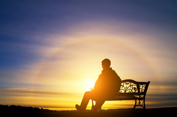 Obraz premium The lonely man sits on a decline