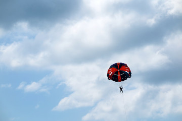 Parasailing man against an overcast sky