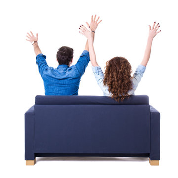 Back View Of Young Cheerful Couple Sitting On Sofa Isolated On W