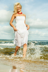 Beautiful blonde girl on beach, summertime