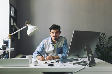 Young graphic designer working in office