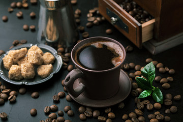 Cup of coffee, grinder and coffee beans