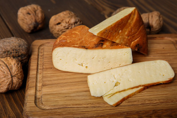 cheese and nuts on cutting board 