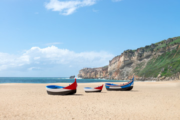 Main beach in Nazare with Traditional colorful boats