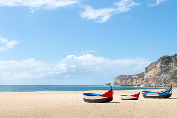 Fototapeta na wymiar Main beach in Nazare with Traditional colorful boats