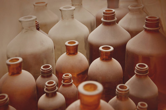 old pharmacy bottles covered with dust