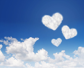 Naklejka na ściany i meble blue sky with hearts shape clouds. Love concept