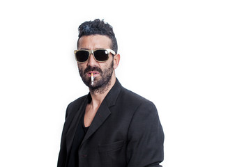 Handsome man portrait wearing sunglasses while smoking cigarette