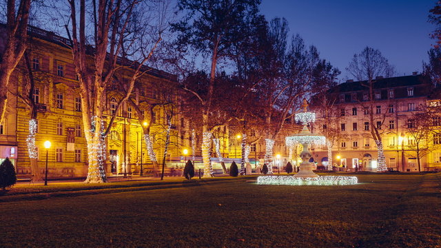 Sunset timelapse of night falling on the fountain at Zrinjevac in Zagreb, decorated with Christmas lights