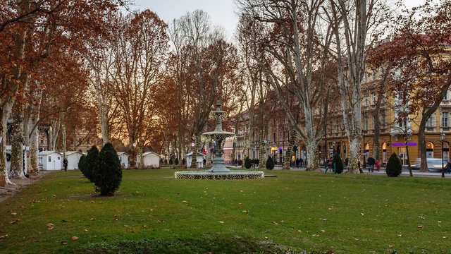 Sunset timelapse of night falling on the fountain at Zrinjevac in Zagreb, decorated with Christmas lights. 