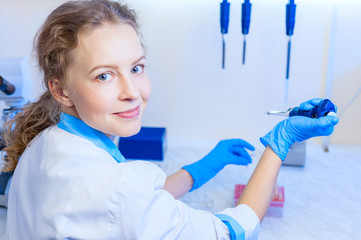 woman scientist chemist with pipettes and test tubes in the workplace modern laboratory