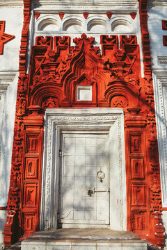 big wooden door, the entrance to the temple decorated with white, red ornamet