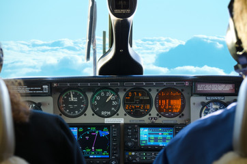 Plane cockpit view with lit up gauges while in flight