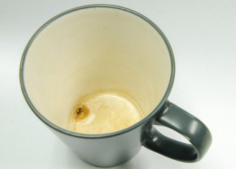 Coffee stains in bottom of cup.