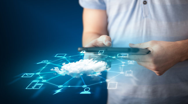 Close up of hand holding tablet with cloud network technology