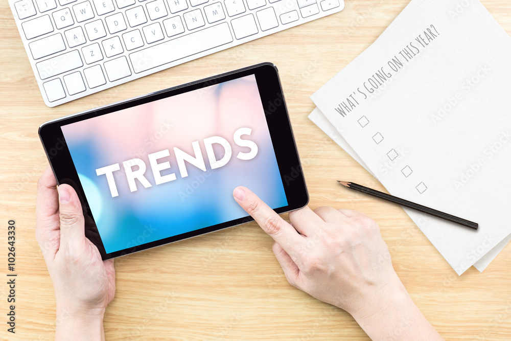 Poster finger touch screen with trends word with keyboard and paper on