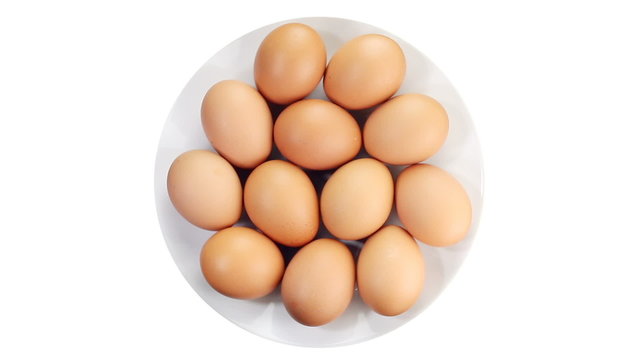 Rotating of egg on white background, top view
