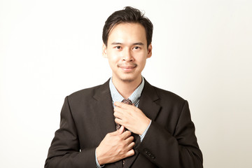 business man tighten his tie with strong friendly and confident face.