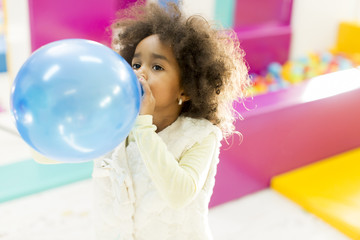 Black little girl with a balloon