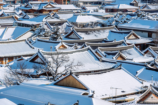 Roof of Jeonju traditional Korean village covered with snow, Jeo