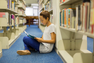 female african american student sitting in library
