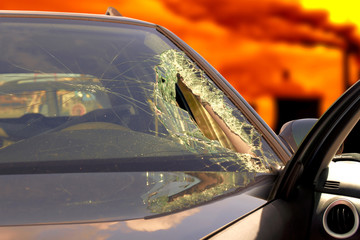 Broken windscreen at black car in traffic accident 