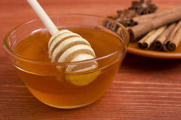 Wooden honey stick and cinnamon sticks.