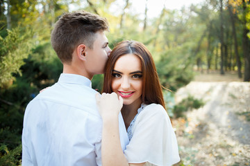 Naklejka premium Couple kissing happiness fun. Interracial young couple embracing laughing on date.