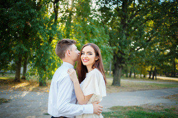 Couple kissing happiness fun. Interracial young couple embracing laughing on date.