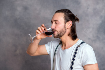 Fototapeta na wymiar young man drinking red wine