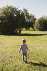 little girl walking and playing in park