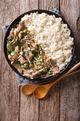 beef stroganoff with mushrooms and rice close-up. Vertical top view 
