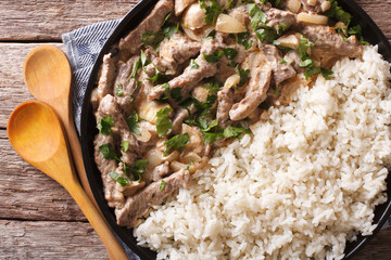 beef stroganoff with mushrooms and rice close-up. horizontal top view 

