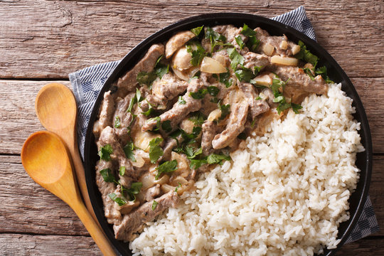 Delicious beef stroganoff with rice close-up. horizontal top view 
