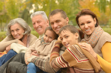 Family relaxing in autumn park