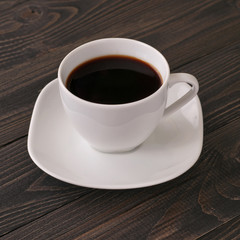 American cup of coffee on dark wooden background