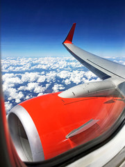 Looking through window aircraft during flight in wing with a blu