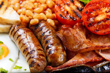 Full English breakfast with bacon, sausage, egg, beans and mushrooms