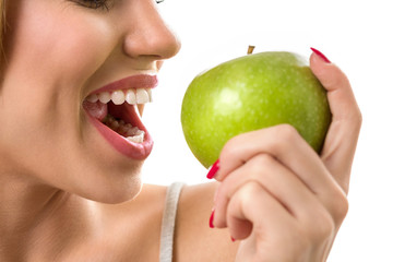 woman biting green apple with heathy teeth