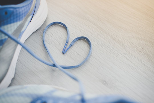 Love sign, Selective focus close up blue sport shoes on gray flo