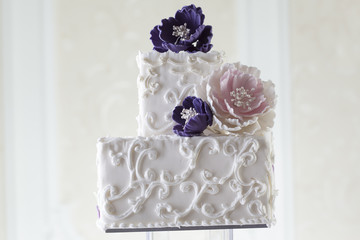Beautiful white wedding cake with floral decoration