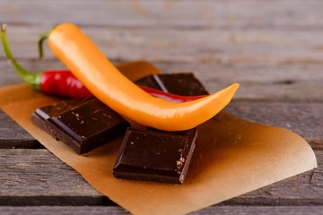 Yellow and red chili pepper with dark chocolate
